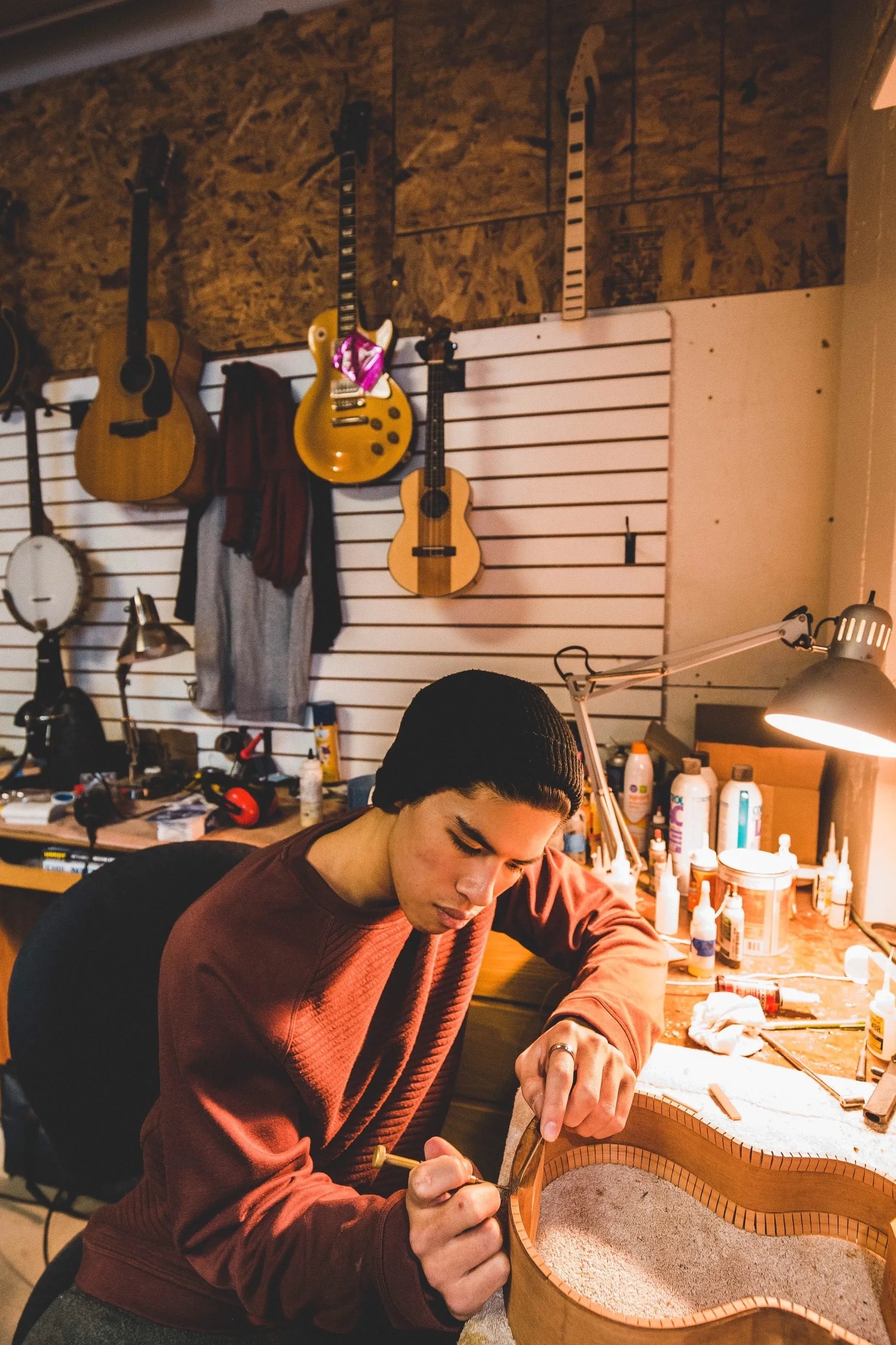 Luthier crafting a ukulele body in the workshop